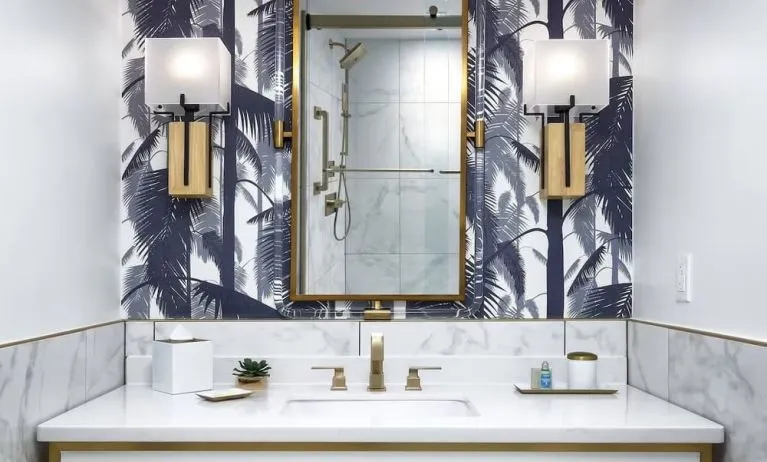 Private guest bathroom with shower and free toiletries at Cadillac Hotel & Beach Club, Autograph Collection.
