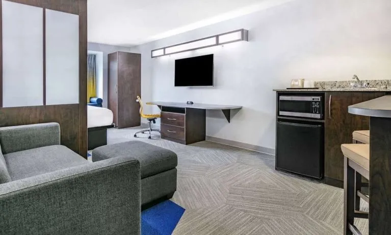Day use room with TV and work desk at Microtel Inn And Suites By Wyndham Austin Airport.