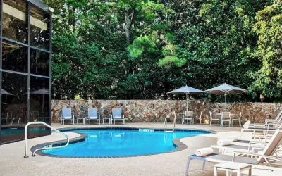 Refreshing outdoor pool surrounded with loungers at Westin Atlanta Airport Hotel.