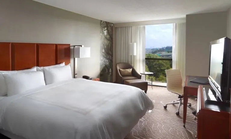 King bedroom with workstation and natural light at Atlanta Marriott Northwest At Galleria.