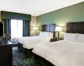 Day use twin room with TV, work desk and window view at the Hampton Inn by Hilton Toronto Airport Corporate Centre.