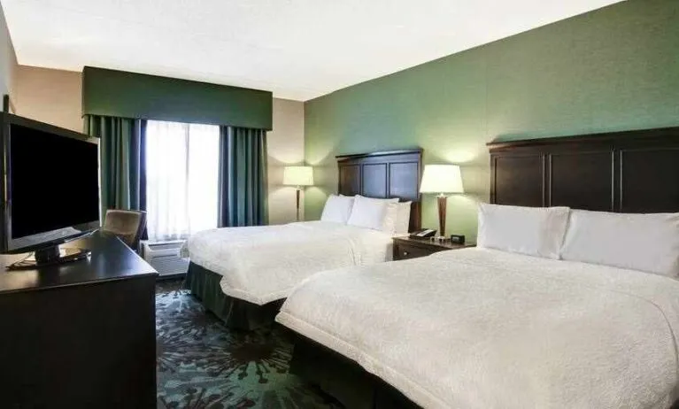 Day use twin room with TV, work desk and window view at the Hampton Inn by Hilton Toronto Airport Corporate Centre.