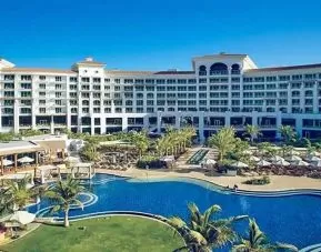 Beautiful outdoors with garden and pool at the Waldorf Astoria Dubai Palm Jumeirah.