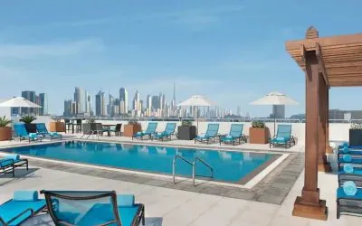 Beautiful outdoor pool with deck and pool chairs at the Hilton Garden Inn Dubai Al Mina