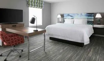 delux king-sized bed with work desk at Hampton Inn Wichita Northwest.