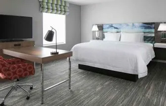 delux king-sized bed with work desk at Hampton Inn Wichita Northwest.