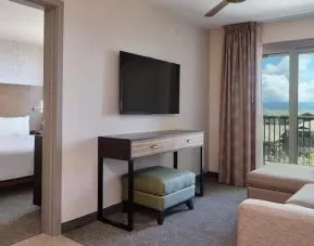 luxurious king bed at Embassy Suites by Hilton Oahu Kapolei.