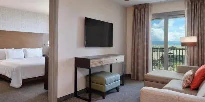 luxurious king bed at Embassy Suites by Hilton Oahu Kapolei.