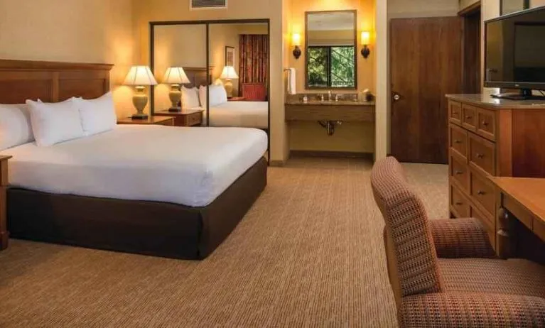 Beautiful king suite with TV screen and desk at the DoubleTree by Hilton Seattle Airport.
