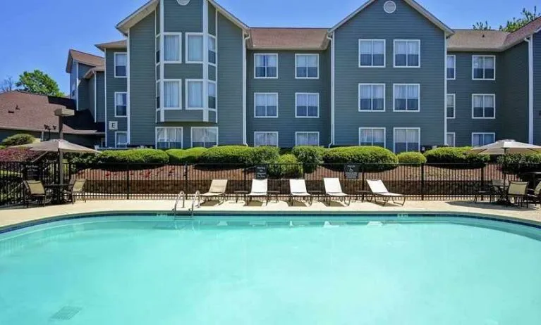 Large outdoor pool with tanning beds and seating at Homewood Suites by Hilton Atlanta-Galleria/Cumberland.