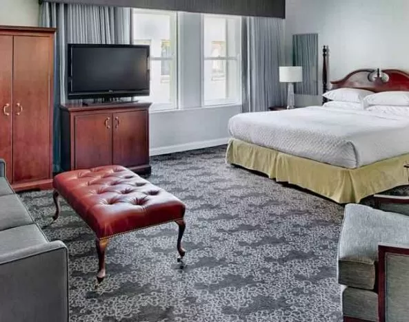 Spacious king studio with sofa and window at the Embassy Suites by Hilton Portland-Downtown.