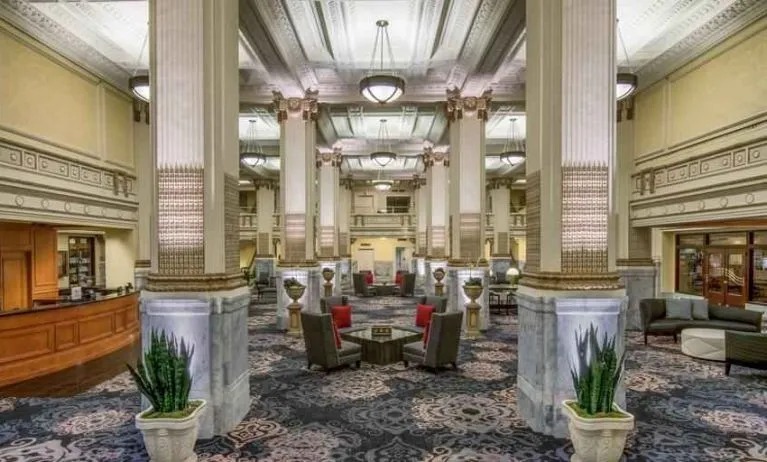 Elegant lobby area with tables and chairs perfect as workspace at the Embassy Suites by Hilton Portland-Downtown.