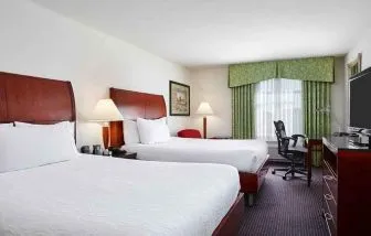 luxurious queen room with TV and work area at Hilton Garden Inn Rockville-Gaithersburg.