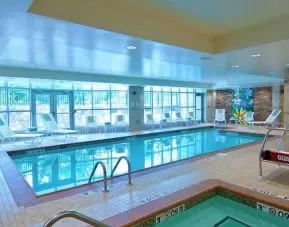 beautiful indoor pool with seating at Homewood Suites by Hilton Rockville-Gaithersburg.