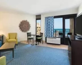 Living area with working station in a king suite at the DoubleTree by Hilton Myrtle Beach.