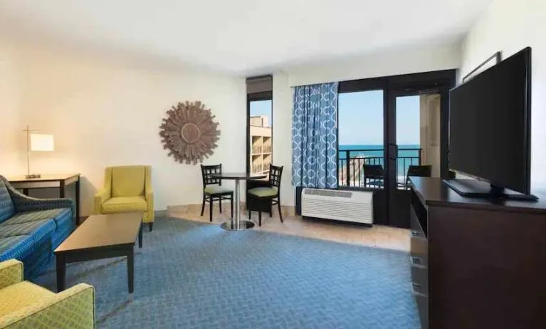 Living area with working station in a king suite at the DoubleTree by Hilton Myrtle Beach.