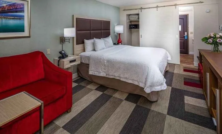 Colorful king suite with natural light at Hampton Inn San Francisco Airport.
