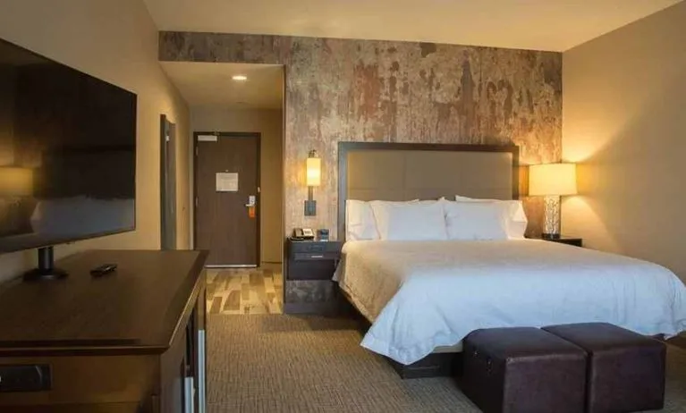 Comfortable king bed with TV at Hampton Inn & Suites Murrieta Temecula.