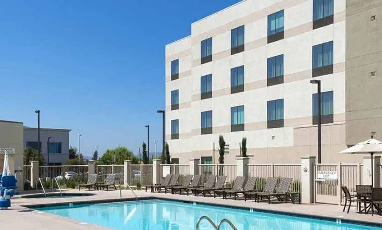 Beautiful outdoor pool with seating area and sun beds at Hampton Inn & Suites Murrieta Temecula.