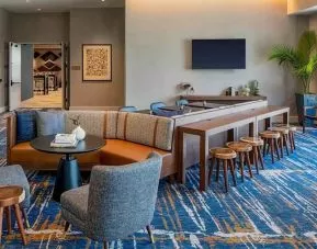 A coworking space with lots of natural light at Hilton Garden Inn Austin University.