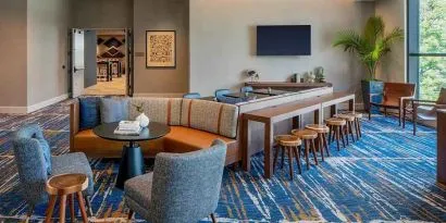 A coworking space with lots of natural light at Hilton Garden Inn Austin University.