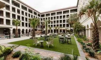 Outdoor workspace with tables and chairs at the Estancia del Norte San Antonio, Tapestry Collection.