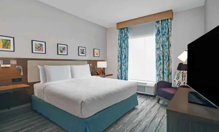 Comfortable bedroom with window at the Hilton Garden Inn Houston Medical Center, TX.