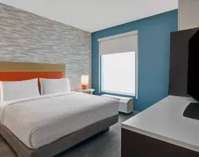 Comfortable bedroom with window at the Home2 Suites by Hilton Houston Medical Center.