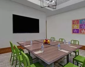 Large meeting room with tables and chairs at the Home2 Suites by Hilton Houston Medical Center.