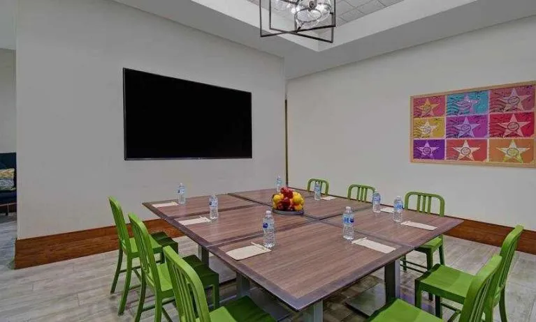 Large meeting room with tables and chairs at the Home2 Suites by Hilton Houston Medical Center.