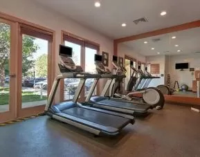 well-equipped fitness center with lots of natural light at Homewood Suites by Hilton - Boulder.
