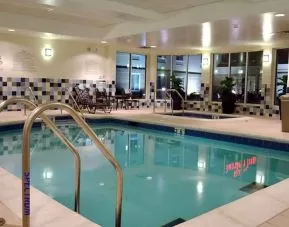 relaxing indoor pool with comfortable seating at Hilton Garden Inn St. Louis Airport.