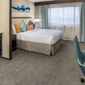 Spacious king room with work desk ideal for working remotely at Embassy Suites by Hilton Seattle Tacoma International Airport.