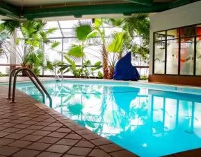 Beautiful indoor pool with plants at the DoubleTree by Hilton Wichita Airport.