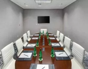 Small meeting room with screen at the DoubleTree by Hilton Wichita Airport.