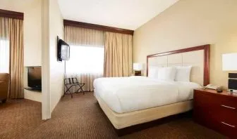 King bedroom with window at the DoubleTree Suites by Hilton Cincinnati-Blue Ash.