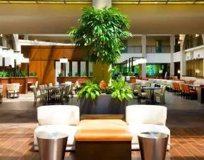 Elegant lobby workspace with plants at the Embassy Suites by Hilton Cincinnati Blue Ash.