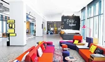 Colorful chairs and couches fill this eclectic stimulating hotel lounge area at Hilton Dubai Al Seef.