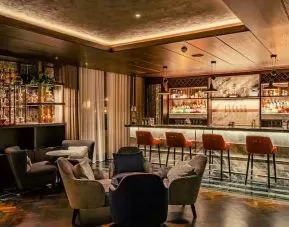 Co-working space along the bar area at the Fellows House Cambridge, Curio Collection by Hilton.