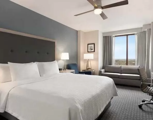 Spacious king suite with work area and TV at Homewood Suites by Hilton University City Philadelphia, PA.