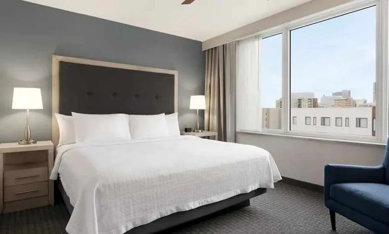 Comfortable king bed with lots of natural light at Homewood Suites by Hilton University City Philadelphia, PA.