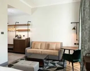 Living room with desk and sofa at the DoubleTree by Hilton Rome Monti.