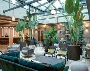 Beautiful lobby workspace with plants at the DoubleTree by Hilton Rome Monti.