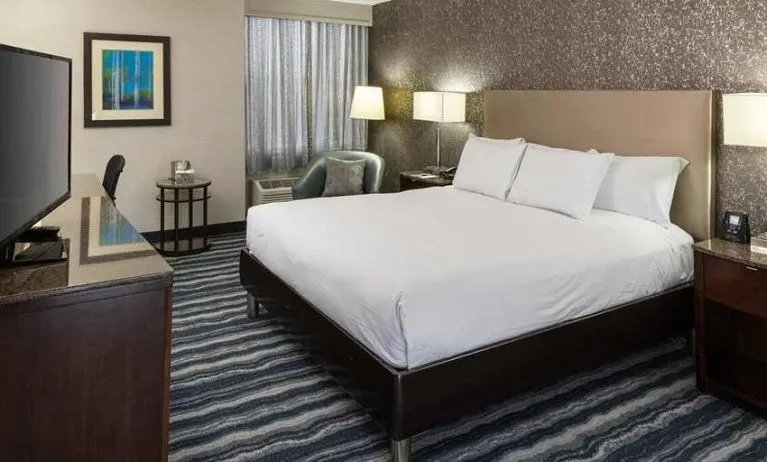 Comfortable king room with TV and work desk ideal for working remotely at DoubleTree by Hilton Hotel Wilmington.