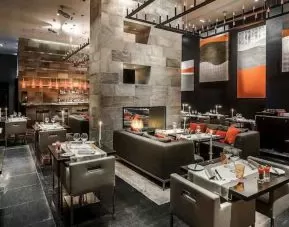 Elegant restaurant with fireplace at the Hilton Evian-les-Bains.