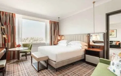 Comfortable king suite with working station at the Hilton Amsterdam.