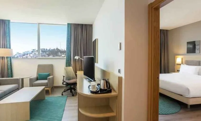 Hotel suite with living room and king size bed at the Hilton Garden Inn Tanger City Center.