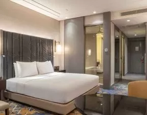 spacious king suite with TV, desk, and lounge area at Hilton Istanbul Bakirkoy.