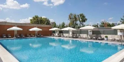 stunning outdoor pool with sun beds and umbrellas at Hilton Istanbul Bakirkoy.