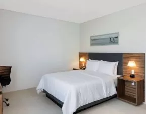 Hotel room with desk and queen size bed at the Hampton Inn by Hilton Cancun Cumbres.